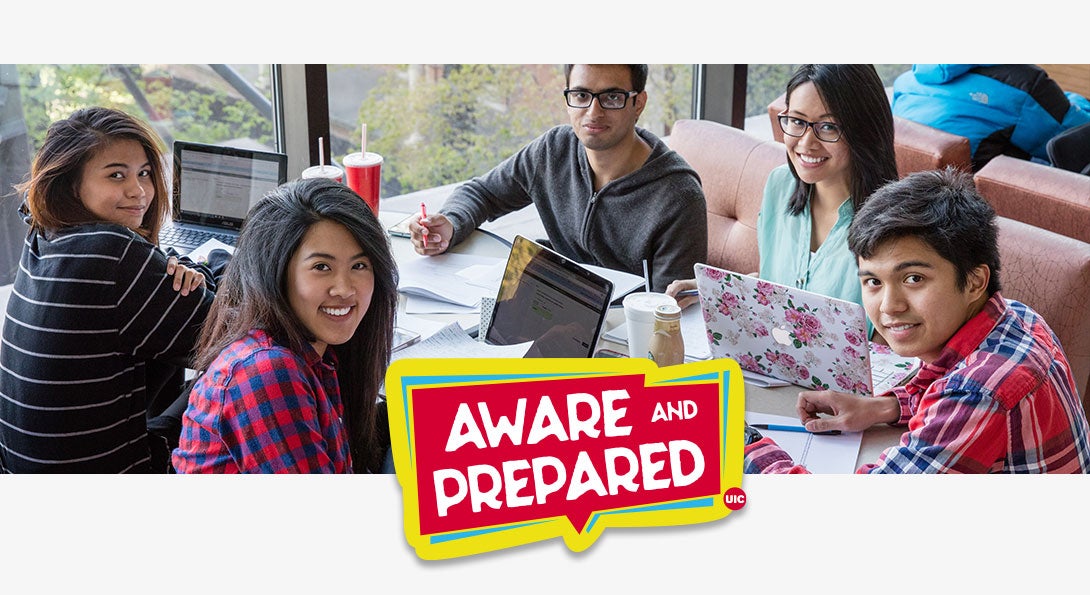 Group of students looking at the camera. They are studying at the library