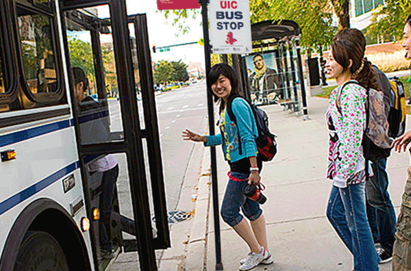 Students boarding a UIC bus providing service to the library