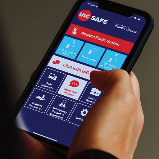 A hand holding a phone showing the home screen/dashboard of the UIC SAFE Mobile app.