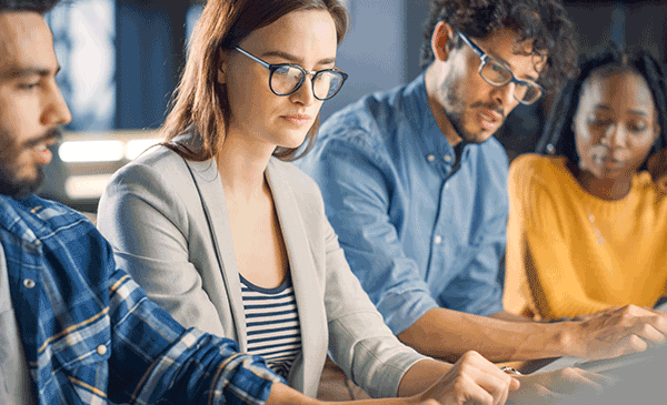 Academics working on a computer side by side